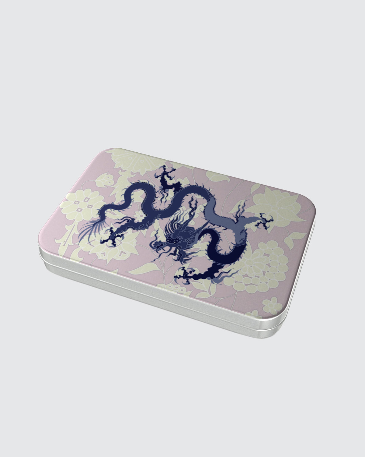 Rectangular tin box with a dragon design on a pink and cream background.