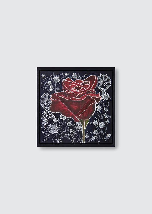A framed acrylic art painting featuring a single red rose with white floral details on a dark background, enclosed in a black frame and displayed against a light gray wall.