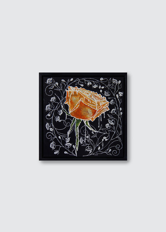 A framed square art painting featuring a stylised orange rose with white floral vine details on a black background, centered against a light gray wall.