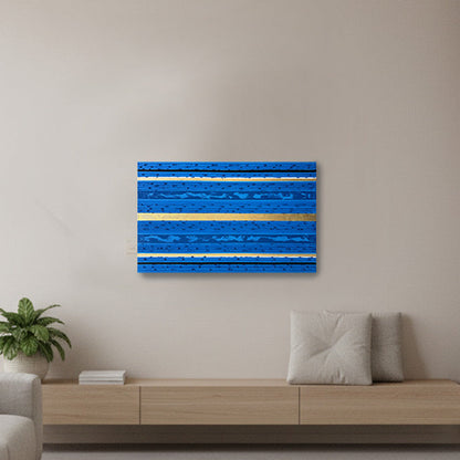 A modern living room with a floating wood console. The focal point is a square blue abstract wall art piece with horizontal textured stripes mounted on the wall.