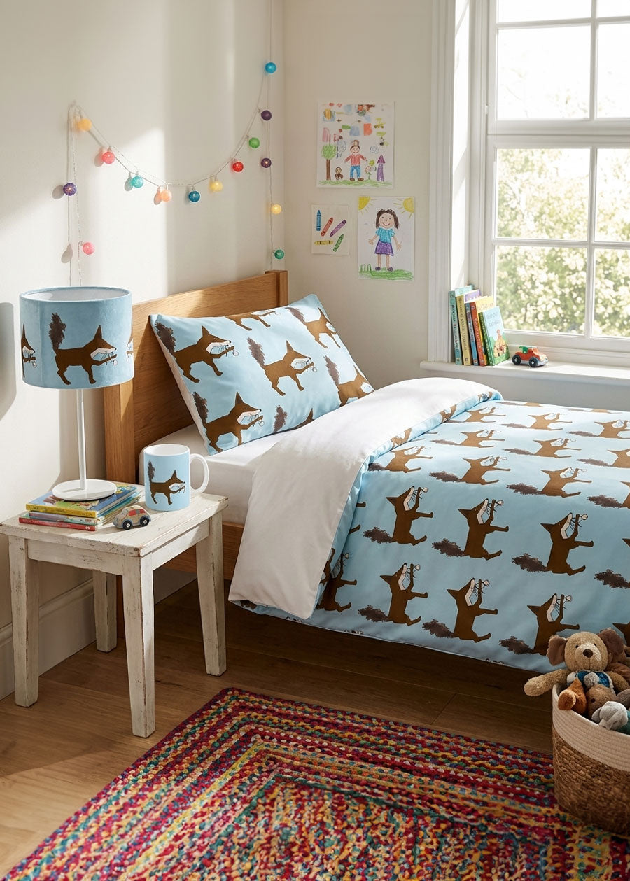 Children's bedroom with fox designed blue bedding, lampshade and mug.