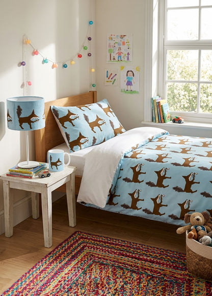 Children's bedroom with fox designed blue bedding, lampshade and mug.