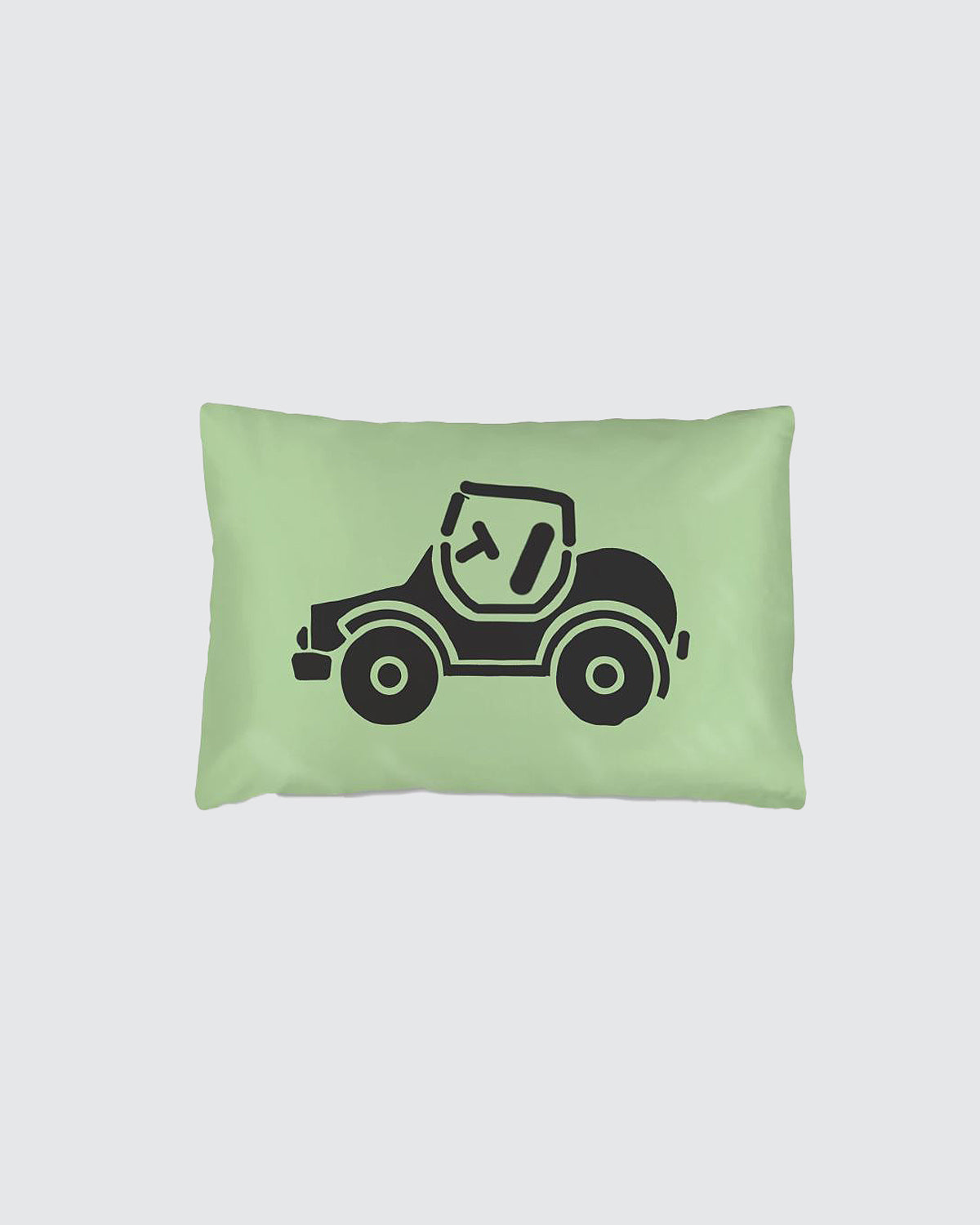 Green silk pillow with a black toy car design.