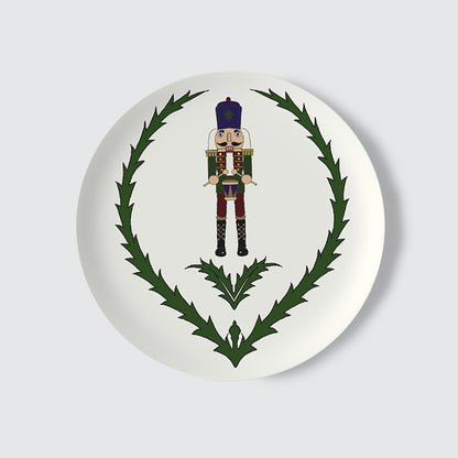 Decorative plate with a nutcracker and thistle design on a white background