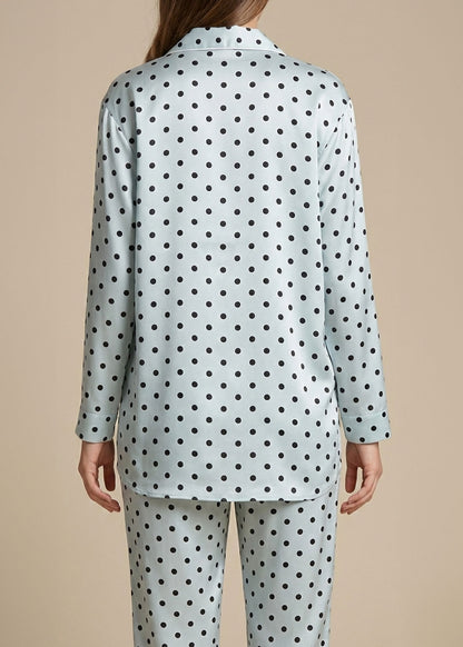 Pale blue and Polka dot pajama set on a beige background.