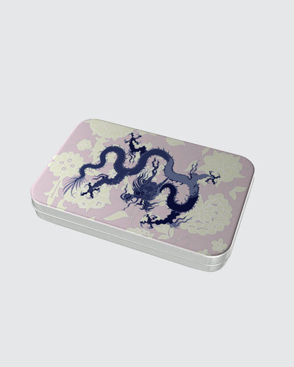 Rectangular tin box with a dragon design on a pink and cream background.