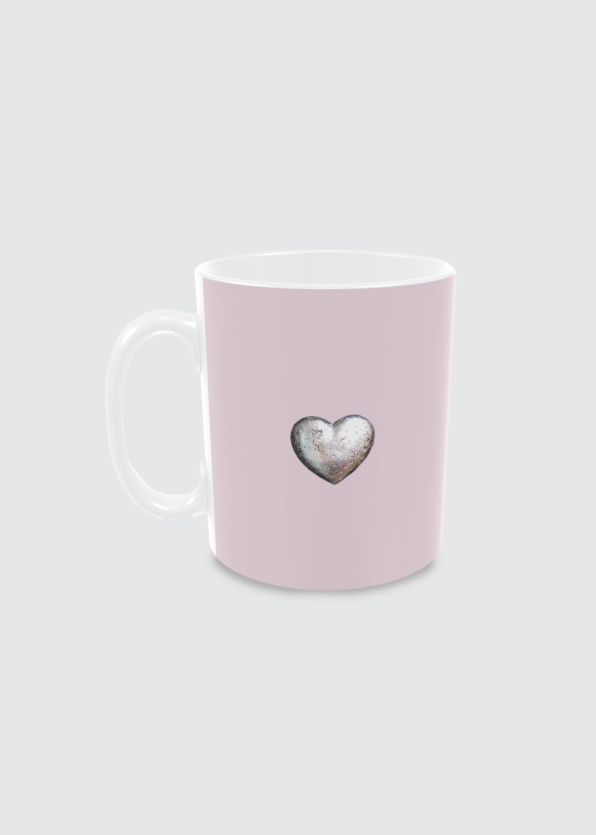 Pink ceramic mug with a silver heart design on a light gray background.