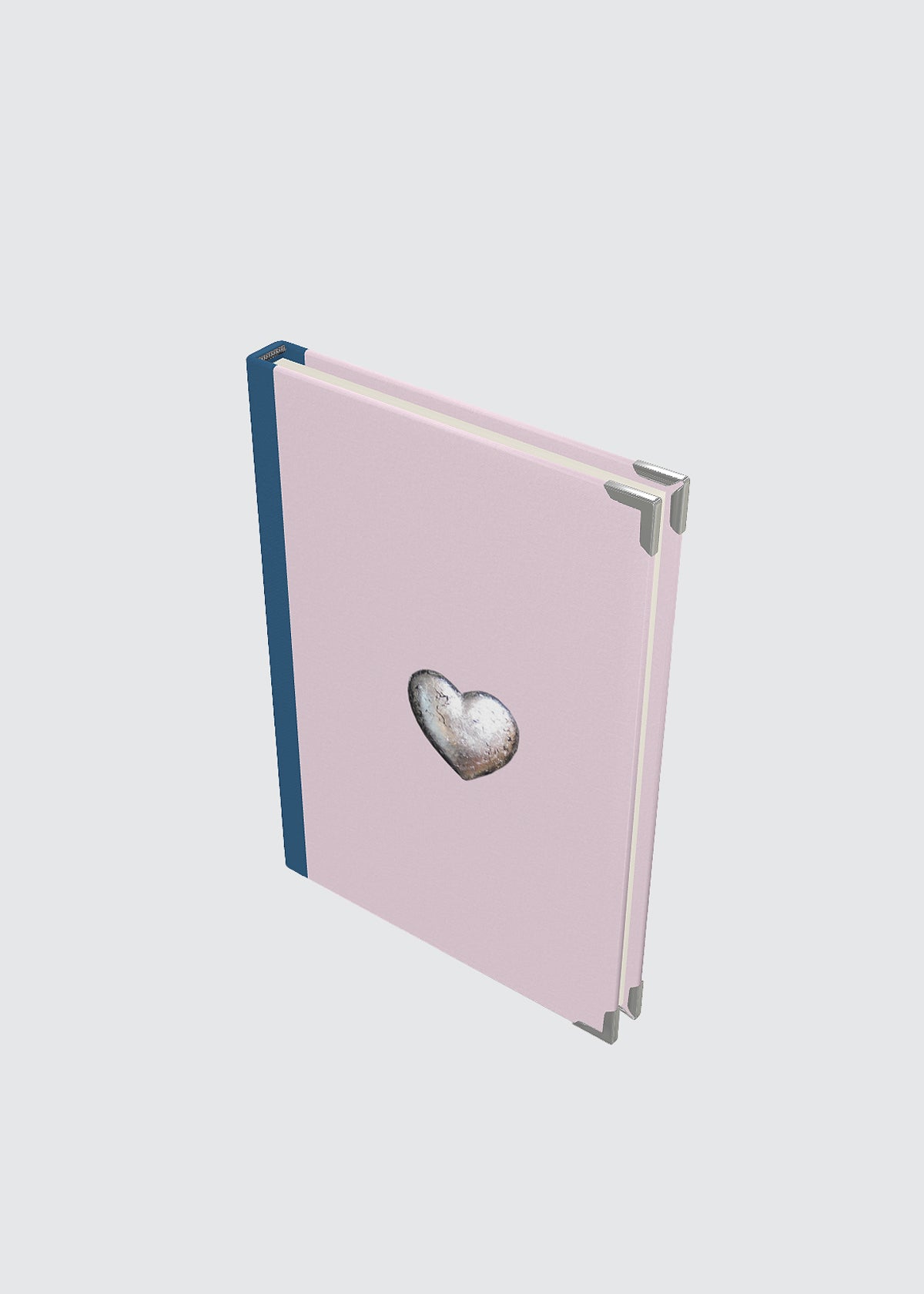 Pink hardback journal notebook with a heart-shaped object.