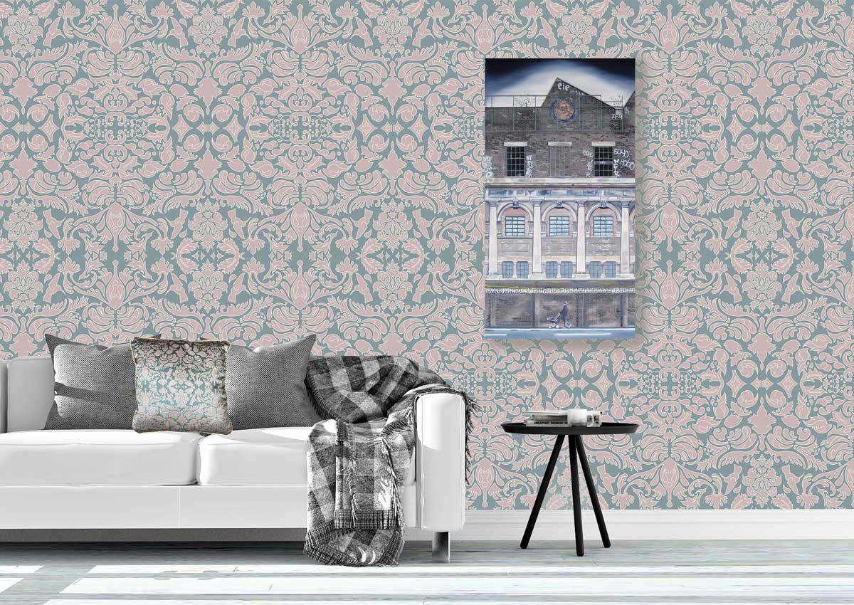 Living room with pink and sage green damask patterned repeat wallpaper, sofa, and framed picture titled RIP by Rose Long on the wall.