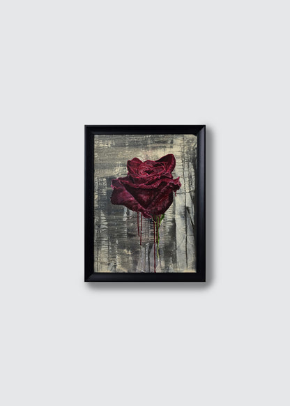 A framed original acrylic painting featuring a textured, dark red rose dripping with paint against a distressed gray and white background, enclosed in a simple black frame.
