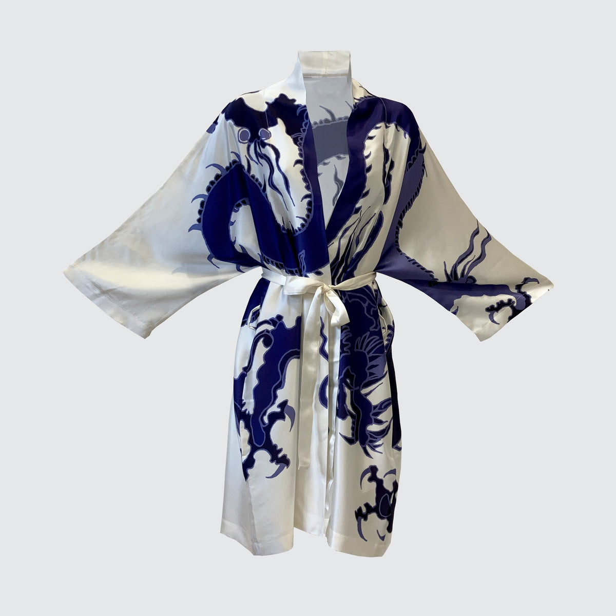 silk kimono with a blue dragon on cream background front view