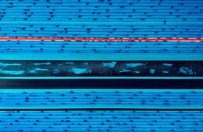 Abstract textured artwork featuring horizontal bands of bright blue, cyan, black, and a vivid red-orange line running across the center.