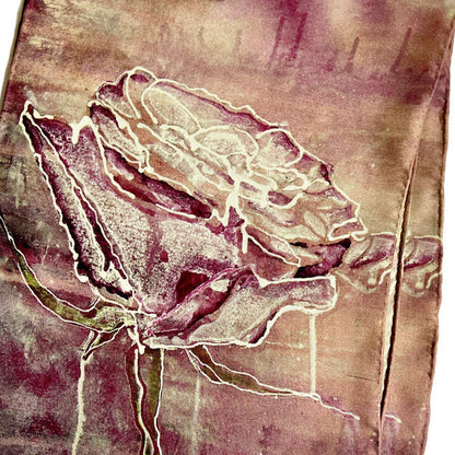 Detail of silk Scarf with floral rose design on violet pink tones and hand rolled edges.