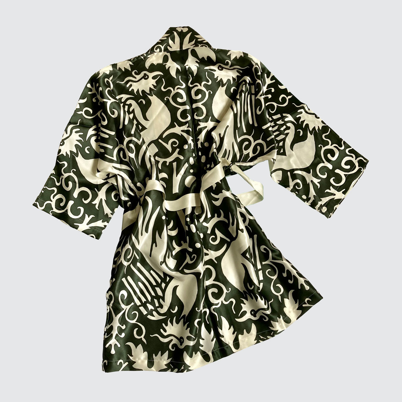 A real silk kimono with a white phoenix pattern on a green background.